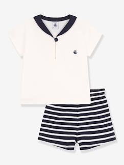 -Een baby 2-delige set PETIT BATEAU met een trui met een col.